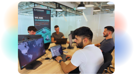 Four security analysts working on their computers.