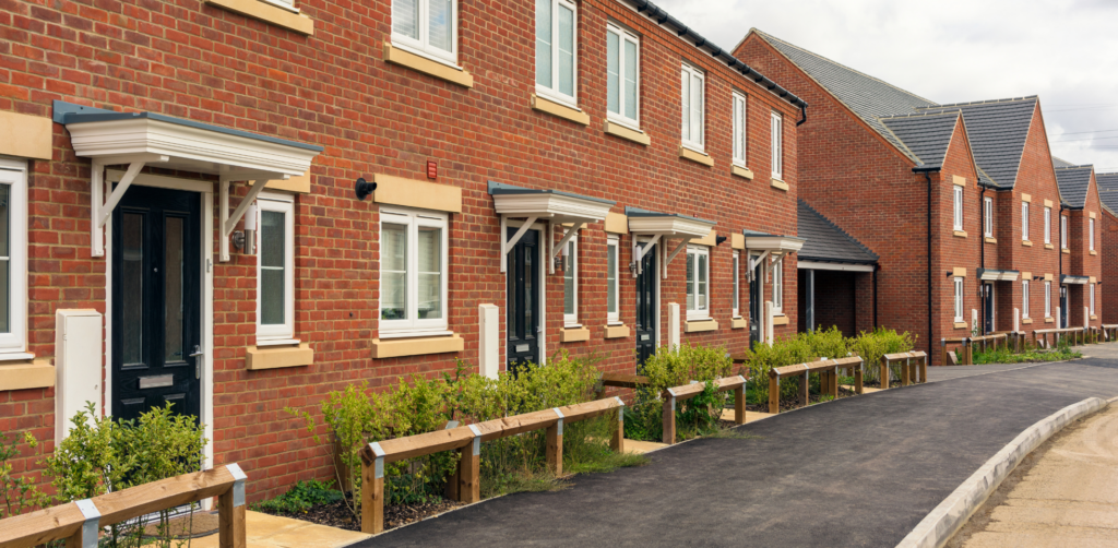 Terraced houses with green bushes infront.